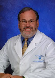 A photo of Timothy Palmer, MD, in his white lab coat