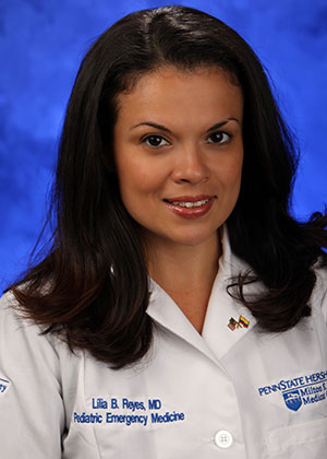 A photo of Lilia Reyes, MD, in her white lab coat
